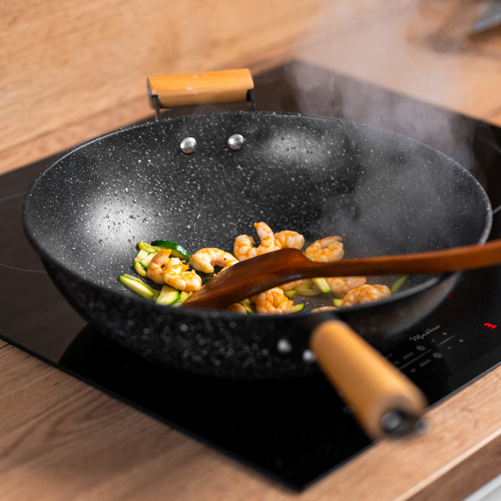 Le Poroshiri zwart antiaanbak wok met deksel detailopname handvat