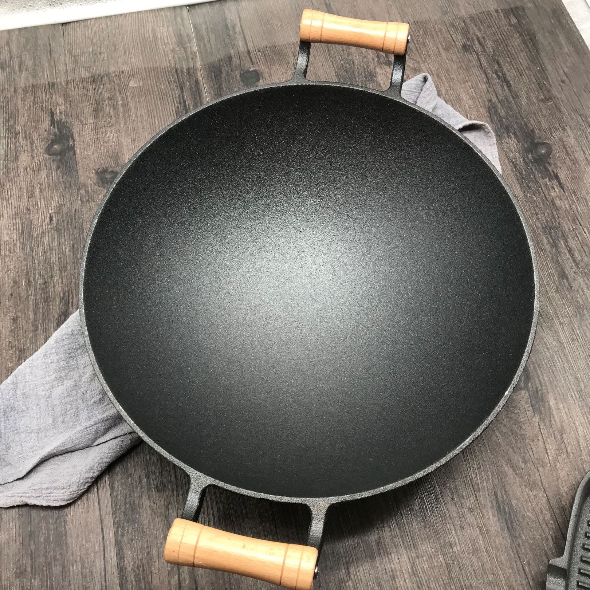 Le Jangsan getijzeren wok 36 cm verhit op gasfornuis tijdens het roerbakken